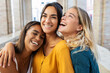 © Xavier Lorenzo - Three happy woman laughing together outdoors. Portrait of diverse female friends having fun enjoying day off at city street in Italy.