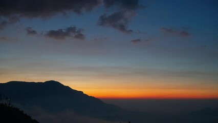 Wall Mural - Beautiful mountain sky over clouds at sunset time