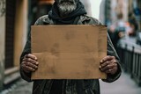Fototapeta  - Homeless person holding up cardboard sign - vagabond panhandling on the street corner