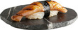 Sushi, nigiri unagi on small round slate plate isolated.