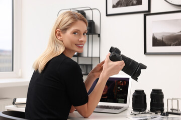 Canvas Print - Professional photographer with digital camera at table in office