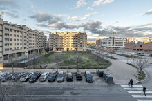 Buildings Of An Urbanization In A Neighborhood On The Outskirts Of Madrid With Undeveloped Plots And Vehicles Parked In A Battery