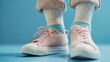 © Aris Suwanmalee - A pastel pink sneakers with a jumper colorful pants.