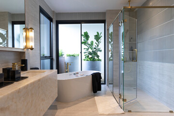 Wall Mural - Luxury bathroom with white bathtub by the window, concept in a modern house