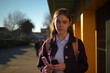 © alisaaa - a 13 year old girl posing with her phone in front of her school