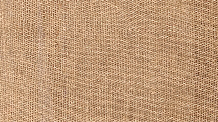 Jute hessian sackcloth woven organic burlap, hemp flax texture pattern background beige cream brown color. 