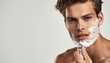 man shaving with razor