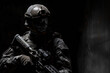 Close-Up of Soldier in Tactical Gear in Shadows. A low-key portrait of a soldier equipped with tactical gear, a helmet, and a firearm, partially concealed in the shadows.