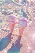 Ice cream sprinkled with glitter  in the sand on the beach by the sea. Iridescent colors with sequins. Summer fashion cosmetic aesthetic concept.