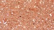 Rose gold sequins and glitter scattered across a surface, shining with a festive sparkle.