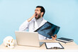 Professional traumatologist in workplace yawning and covering wide open mouth with hand