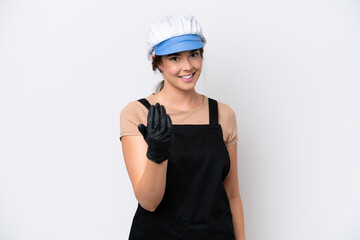 Wall Mural - Fishmonger brazilian woman wearing an apron isolated on white background inviting to come with hand. Happy that you came