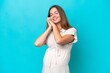 © luismolinero - Young caucasian woman isolated on blue background pregnant and happy