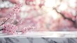 Marble stone table top with Sakura on blur bokeh background. For display or montage you products. Blank space for beauty product display