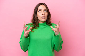 Wall Mural - Young caucasian woman isolated on pink background stressed overwhelmed