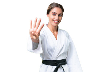 Wall Mural - Young Uruguayan woman doing karate over isolated background happy and counting four with fingers