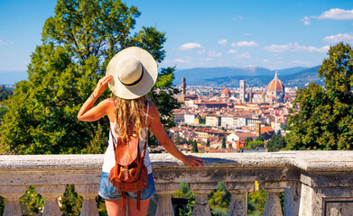 Wall Mural - back view of young female tourist in Italy- Florence city landscape panoramic view