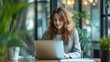 © twentyone - Woman working laptop at office, Beautiful young woman in casual clothing using laptop, green leaf blur background,