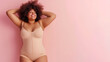 © Elena - Body positivity, happy smiling plus size model in flesh color underwear on pink background, copy space for text. Generative AI