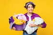© ViDi Studio - Young dissatisfied confused sad woman wear purple shirt do housework tidy up holding basin with laundry clothes look camera isolated on plain yellow background studio portrait. Housekeeping concept.