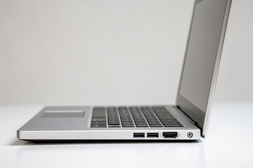 Poster - A modern laptop computer on a clean white table, suitable for technology or workspace concepts