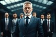 © Fotograf - A man in a suit standing in front of a group of men. Ideal for business concepts