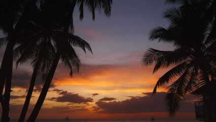 Wall Mural - Silhouetted people and palms near sea. Sunset at tropical White beach, Boracay island, Philippines, 4k