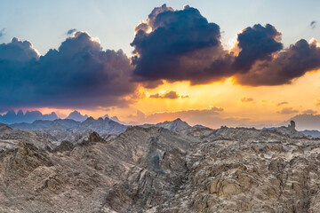 Wall Mural - Dramatic wide Sunset panorama over Red Sea Hills mountain chain and Sahara desert. Sharp mountain peaks, wide photo. Hurghada, Egypt