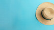 Summer banner, top view, straw hat isolated on blue background with copy space. The concept of summer beach vacation.