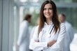 © opolja - Beautiful young female medical doctor is looking at camera and smiling while standing in hospital.