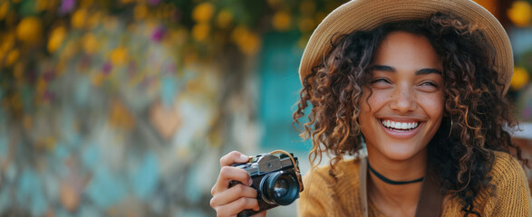 Wall Mural - A joyful young model takes a close-up photo while holding a camera in hand