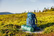 Hiking backpack with mat during trek in mountains. Camping and trekking equipment