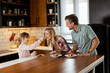 © BGStock72 - Joyful Family Enjoying Homemade Chocolate Cake in Cozy Kitchen