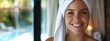 a woman with a towel on her head smiling