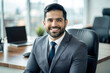 © Tapos - Young Hispanic Businessman in Business Suit: Portrait of Satisfied Boss Smiling and Looking at Camera Inside Office
