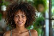 © Pinklife - A beautiful young woman with curly hair and a bright smile posing in a natural light setting