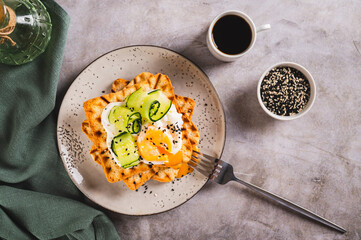 Wall Mural - Toasts with cream cheese, cucumber, poached egg and sesame seeds on a plate top view