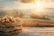 Potatoes harvested in a wooden box with field and sunset in the background.