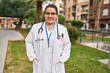 © Krakenimages.com - Young beautiful plus size woman doctor smiling confident standing at park