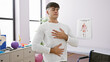 © Krakenimages.com - At his balance point, a portrait of a young, handsome hispanic man finding calm by meditating and taking a deep breath, relaxing in the indoor room of a rehab clinic, conquering respiratory problems