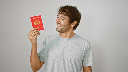 Poster - Confident young man exuding joy, proudly flaunts his malaysian passport, standing isolated against a white background