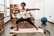 © Krakenimages.com - African american woman smiling confident training yoga at home