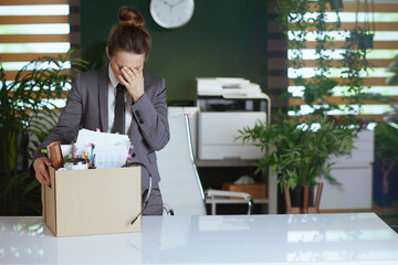 Wall Mural - sad modern woman worker in modern green office