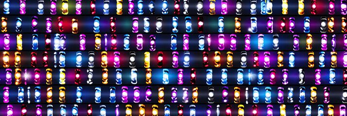 Leinwandbilder - A vibrant display of multicolored lights dancing across a textured wall, creating a mesmerizing visual experience