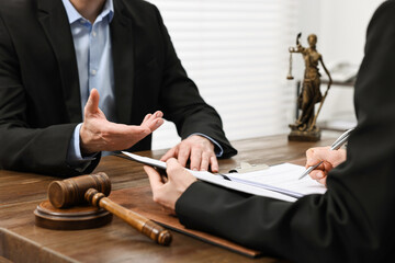 Wall Mural - Woman signing document in lawyer's office, closeup