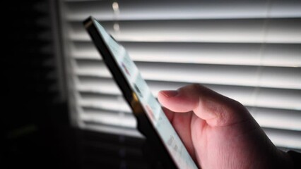 Close up of male hand looking for a game on phone 5