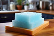 A practical disposable kitchen sponge with soap residue on a countertop