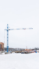 the construction site of an apartment building in the winter from a height