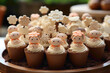 A cute and attractive disposable cupcake topper with tiny figurines on a dessert display