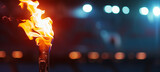 Fototapeta  - Blurred olympic torch flame burning in sports arena with space for text